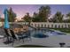 Gorgeous pool with integrated slide and hot tub, surrounded by lush landscaping and lounge chairs at 13365 N 74Th St, Scottsdale, AZ 85260