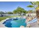 Stunning pool area with rock features, a slide, a sport court, and lush landscaping, perfect for outdoor fun at 13365 N 74Th St, Scottsdale, AZ 85260