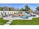 Luxurious swimming pool with a rock water slide, surrounded by lush landscaping and comfortable lounge chairs at 13365 N 74Th St, Scottsdale, AZ 85260