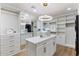 Luxury walk-in closet boasts ample storage, a central island, and stylish lighting at 13365 N 74Th St, Scottsdale, AZ 85260