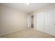 This bedroom offers neutral carpet and paint with closet and door access at 14237 W Aster Dr, Surprise, AZ 85379