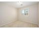 A carpeted bedroom has a window that provides natural light at 14237 W Aster Dr, Surprise, AZ 85379