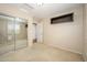 Bedroom features neutral carpet and paint, closet and shelves plus entry door at 14237 W Aster Dr, Surprise, AZ 85379