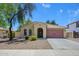 Charming single-story home featuring a well-manicured yard and a two-car garage at 14237 W Aster Dr, Surprise, AZ 85379