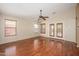 Living room boasts wood floors, a ceiling fan, and French doors leading to the yard at 14237 W Aster Dr, Surprise, AZ 85379