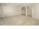 Expansive living room featuring neutral walls and carpet with arched entries at 14237 W Aster Dr, Surprise, AZ 85379