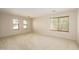Spacious living room with neutral carpet, large windows, and natural light at 14237 W Aster Dr, Surprise, AZ 85379