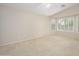 A bright main bedroom offers large windows and plush carpeting at 14237 W Aster Dr, Surprise, AZ 85379
