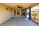 Covered patio includes ceiling fan and door and window access to the home at 14237 W Aster Dr, Surprise, AZ 85379
