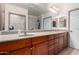 The bathroom has a double sink vanity with updated fixtures and a large mirror at 14575 W Mountain View Blvd # 12107, Surprise, AZ 85374