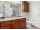 Bathroom features wood cabinetry, a large vanity, and a view of the shower at 14575 W Mountain View Blvd # 12107, Surprise, AZ 85374
