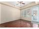 Cozy bedroom with hardwood floors, natural light from a large window, and a private balcony at 14575 W Mountain View Blvd # 12107, Surprise, AZ 85374