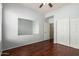 Bedroom featuring a ceiling fan, closet with sliding doors, and hardwood floors at 14575 W Mountain View Blvd # 12107, Surprise, AZ 85374