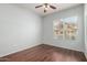 The bedroom has hardwood floors, light blue walls, and a large window at 14575 W Mountain View Blvd # 12107, Surprise, AZ 85374