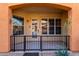 Inviting front porch with a black metal fence and tile flooring, perfect for enjoying the outdoors at 14575 W Mountain View Blvd # 12107, Surprise, AZ 85374