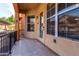 Spacious front porch featuring tile flooring, large windows, and a secure entrance door at 14575 W Mountain View Blvd # 12107, Surprise, AZ 85374