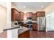 Well-equipped kitchen with stainless steel appliances, granite countertops, and dark wood cabinets at 14575 W Mountain View Blvd # 12107, Surprise, AZ 85374