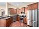 Modern kitchen featuring stainless steel appliances, dark wood cabinets, and sleek granite countertops at 14575 W Mountain View Blvd # 12107, Surprise, AZ 85374