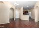Spacious living room with hardwood floors, open to the kitchen, with natural light at 14575 W Mountain View Blvd # 12107, Surprise, AZ 85374