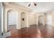Bright and airy living room with hardwood floors and arched openings to other rooms at 14575 W Mountain View Blvd # 12107, Surprise, AZ 85374