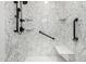 The walk-in shower features marbled walls, a shower bench, and safety bars at 14575 W Mountain View Blvd # 12107, Surprise, AZ 85374