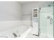 A bathroom with a soaking tub and a glass enclosed shower at 14624 N 90Th Ln, Peoria, AZ 85381