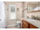 Bright bathroom featuring granite countertops, wood cabinets, a window with shutters, and ample space at 14624 N 90Th Ln, Peoria, AZ 85381