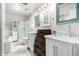 Bright bathroom features double sinks with marble counters and white cabinetry, complemented by a glass-enclosed shower at 14624 N 90Th Ln, Peoria, AZ 85381