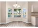 Charming breakfast nook with bay windows offering serene views of the pond at 14624 N 90Th Ln, Peoria, AZ 85381