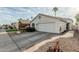 Inviting single-level home with a two-car garage, complemented by desert landscaping for a low-maintenance lifestyle at 14624 N 90Th Ln, Peoria, AZ 85381