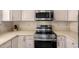Modern kitchen appliances including stainless steel stove, oven and microwave at 14624 N 90Th Ln, Peoria, AZ 85381
