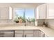 Bright and airy kitchen with modern appliances and a large window with natural light at 14624 N 90Th Ln, Peoria, AZ 85381