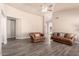 Spacious living room featuring modern flooring, neutral walls and comfortable leather seating at 14624 N 90Th Ln, Peoria, AZ 85381