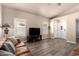 Cozy living room featuring plantation shutters, modern flooring, and entertainment area at 14624 N 90Th Ln, Peoria, AZ 85381