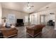 Bright living room with vaulted ceilings, plantation shutters, and a ceiling fan at 14624 N 90Th Ln, Peoria, AZ 85381
