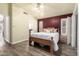 This spacious bedroom boasts a king bed, ensuite bath, and sliding glass door leading to the backyard at 14624 N 90Th Ln, Peoria, AZ 85381