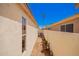 Narrow side yard features gravel, potted plants, air conditioning unit and the side of the home with a window at 14624 N 90Th Ln, Peoria, AZ 85381