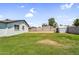 Spacious backyard featuring green grass, block wall, and storage shed, ideal for outdoor activities at 14635 N 37Th Pl, Phoenix, AZ 85032