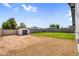 Spacious backyard area with dirt, a block wall, shed, and ample space for various purposes at 14635 N 37Th Pl, Phoenix, AZ 85032
