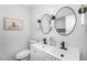Modern bathroom boasting double sinks, sleek mirrors, elegant lighting, and black matte finishes at 14635 N 37Th Pl, Phoenix, AZ 85032