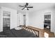 Bright bedroom featuring light wood floors, a black metal bed, and access to the bathroom and closet at 14635 N 37Th Pl, Phoenix, AZ 85032