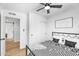 Cozy bedroom with a sliding door closet and ceiling fan with an abstract writing on the wall at 14635 N 37Th Pl, Phoenix, AZ 85032