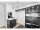 Well-organized walk-in closet with black drawers, shelving, and stylish lighting fixture at 14635 N 37Th Pl, Phoenix, AZ 85032