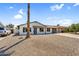 Single-story house with desert landscaping and a long driveway leading to an attached garage, showcasing practicality at 14635 N 37Th Pl, Phoenix, AZ 85032
