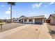 Charming single-story home featuring a low-maintenance front yard with a long driveway and attached garage at 14635 N 37Th Pl, Phoenix, AZ 85032