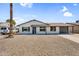 Single-story house with low-maintenance landscaping, a long driveway, and attached garage, offering convenience and curb appeal at 14635 N 37Th Pl, Phoenix, AZ 85032