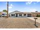 Charming home with a desert landscape front yard and ample parking provided by the long driveway and attached garage at 14635 N 37Th Pl, Phoenix, AZ 85032
