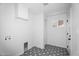 Bright laundry room with patterned flooring, offering both style and functionality at 14635 N 37Th Pl, Phoenix, AZ 85032