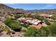 Scenic aerial view of a desert home with mountain backdrop, and lush green landscaping at 14760 E Paradise Dr, Fountain Hills, AZ 85268