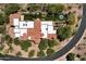 Aerial view of a desert home showcasing the pool, distinctive roof design, and mature landscaping at 14760 E Paradise Dr, Fountain Hills, AZ 85268